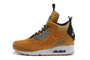 Side profile of a tan Nike Air Max 90 high-top shoe with a white midsole and visible Air unit