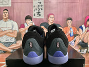 Rear view of black Jordan basketball sneakers with purple heel accents and translucent purple soles.