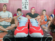 Front view of red high-top basketball shoes with light blue laces and white accents