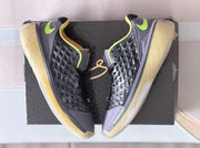 Pair of black and gray Nike Kobe basketball sneakers with neon yellow accents displayed over a black box.