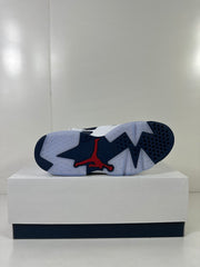 Bottom view showing the translucent navy outsole and red Jumpman detail.