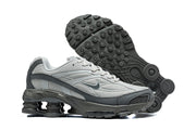 Grey Nike Shox Ride 2 sneakers shown from the side and with the patterned outsole visible.