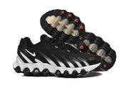 Side and outsole views showing the black-and-white sneakers’ sculpted sole and tread.