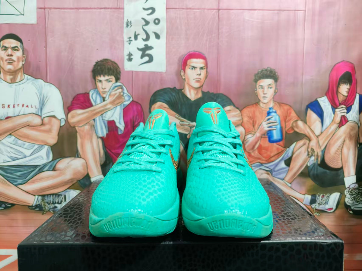 Front view of turquoise Nike basketball shoes with gold-tone tongue logos