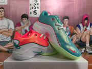 Angled view of red and teal Nike sneakers showing side panels, swooshes, snowflake detailing and green outsoles.