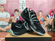 Black Nike basketball sneakers displayed in an angled stacked position, showing the graphic side panels and translucent outsoles.