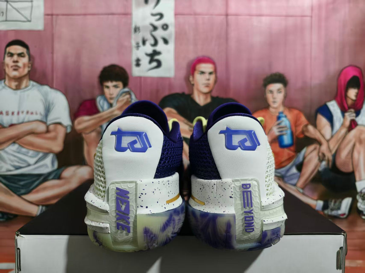 Rear view of white and purple Nike basketball sneakers with blue-purple heel branding, displayed on a shoe box.