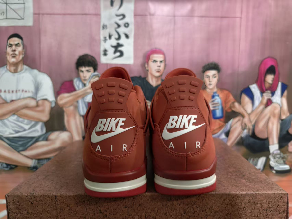 Rear view of red low-top sneakers showing heel branding, tonal panels, and a light-colored midsole accent.