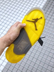 Underside view showing the yellow translucent outsole and traction pattern.