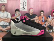 Side view of a black, light-colored, and pink basketball sneaker with visible Air Zoom text