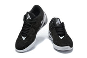 Pair of black low-top basketball shoes with white and silver accents shown from a front three-quarter angle.