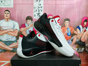 Angled view of the pair highlighting the contrasting white and black panels, red details, and Jordan logos.