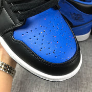 Close-up of a perforated blue toe box with speckled detailing and black trim.