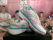 Angled view of the white and multicolor Adidas basketball sneakers with lace-up fronts and chunky soles