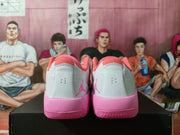 Rear view of white and pink Jordan basketball sneakers showing pink heel sections, collars, and Jumpman logos.