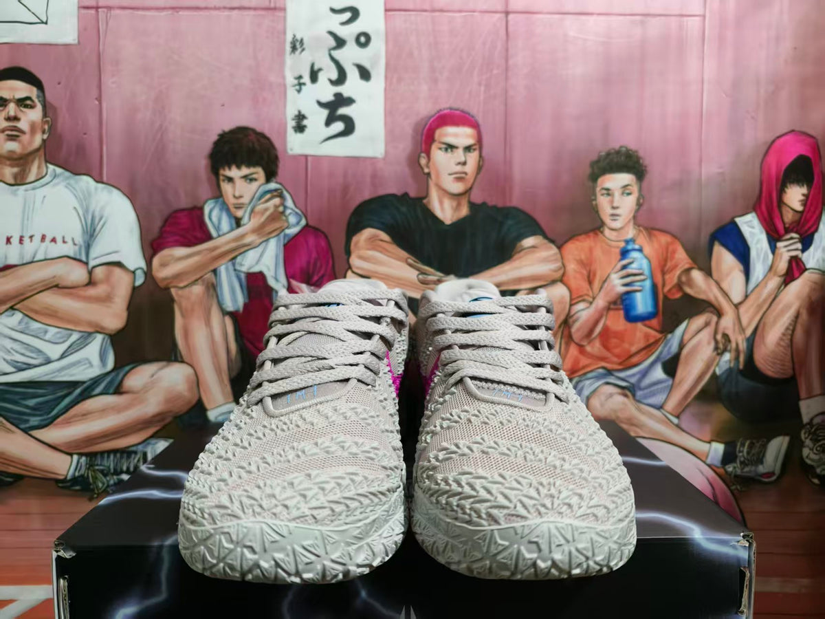 Front view of light pink Nike basketball sneakers with gray laces and textured uppers on a black shoebox.