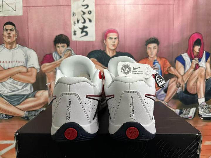 Rear view of white Nike KD basketball shoes with red and black details