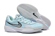 Light blue Nike G.T Cut Cross EP basketball sneakers with black swoosh details and a white patterned outsole.