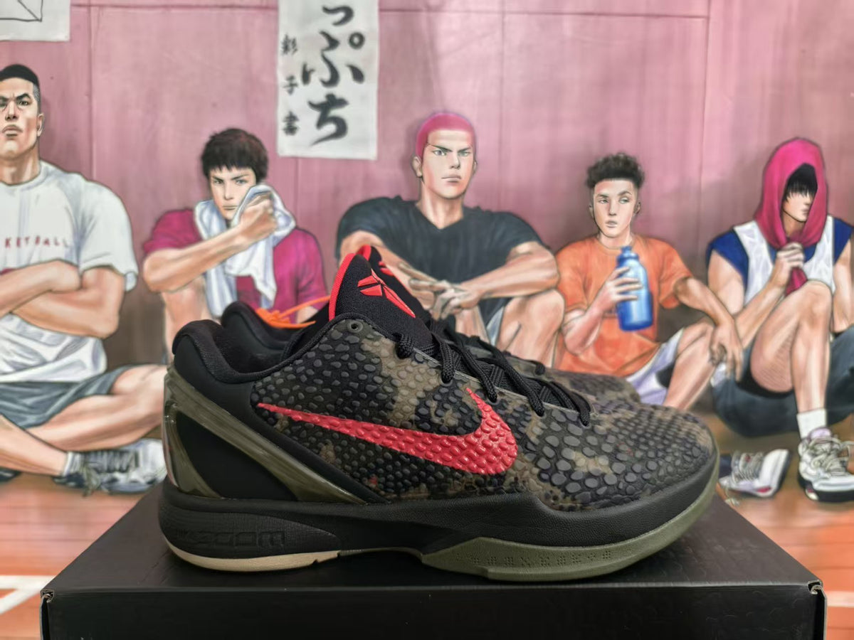 Pair of black, olive, and red camouflage Nike basketball sneakers shown from the side on a black box.