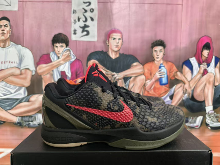 Pair of black, olive, and red camouflage Nike basketball sneakers shown from the side on a black box.