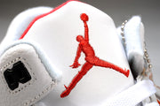 Close-up of the white tongue with a red Jumpman logo and black lace hardware.