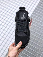 Front-facing view of the black sneaker showing the tongue branding, laces, and toe box.