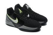 Three-quarter view of the black and gray sneakers with bright yellow and white side accents.