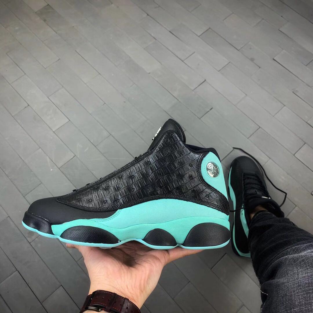 Side view of black and bright green Jordan Air Jordan 13 sneakers