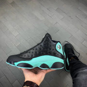 Side view of black and bright green Jordan Air Jordan 13 sneakers