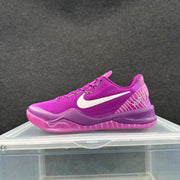 Side profile of a purple Nike sneaker showing the white Swoosh, lace-up upper and translucent outsole.