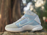Opposite side view showing the light blue upper, white Swoosh, padded collar, and sculpted midsole.
