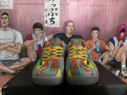 Front view of the pair showing multicolor patterned uppers, yellow laces, gray toe areas, and translucent-looking gray outsoles.