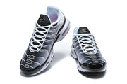 Front view of a pair of Nike Air Max Plus sneakers in black, grey, and pale pink