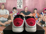 Rear view of white and red Nike sneakers showing red heel panels, black collars, and heel graphics.
