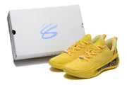 Yellow sneakers displayed beside a presentation box with a visible graphic mark.