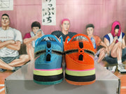 Rear view of mismatched orange and blue basketball shoes with contrasting layered soles.
