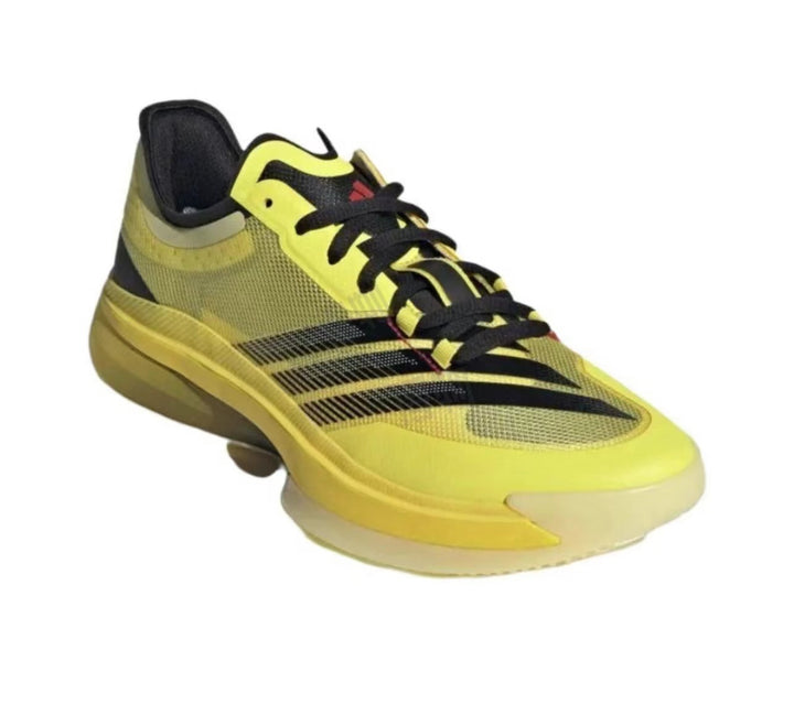 Yellow and black low-top sneaker with black laces, layered side stripes, and a contrasting light-colored toe and outsole.