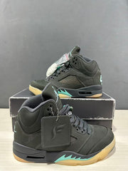 Close angled view of the Jordan Air Jordan 5 pair showing the padded collars, lace areas, hangtags, and aqua midsole details.