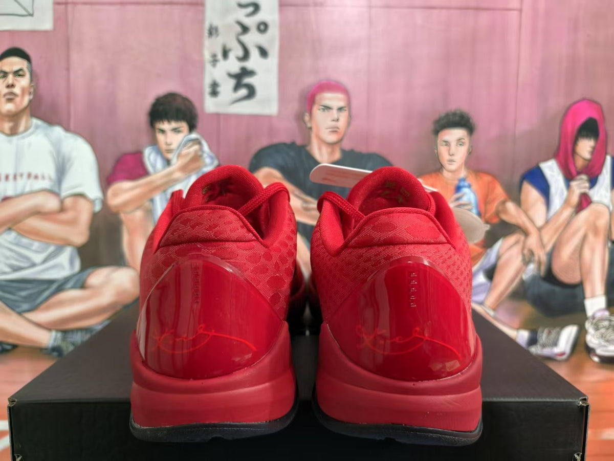 Rear view of red Nike basketball sneakers showing patterned uppers, padded collars, and black outsole edges.