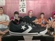 Side view showing the white star-and-chevron graphic on a black sneaker.