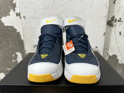 Front view of Nike Kobe 2K5 shoes showing the navy laces, white strap, and yellow accents.