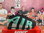 Side view of one black and green Nike sneaker showing the structured upper, contrasting midsole sections, and heel cushioning unit.