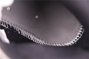Close-up of stitched detailing on a grey sneaker panel
