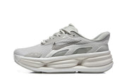 Side view of a light grey Nike sneaker with a textured upper and sculpted sole.