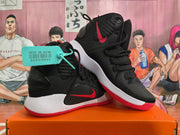 Pair of black Nike high-top basketball shoes with red accents and white midsoles.