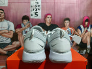 Rear view of the pair of white Nike shoes showing heel details and textured outsoles.