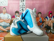 Pair of white and blue Nike basketball shoes shown from the side