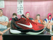 Side view showing the textured red upper, white Swoosh, black overlays, and Nike Zoom midsole branding.