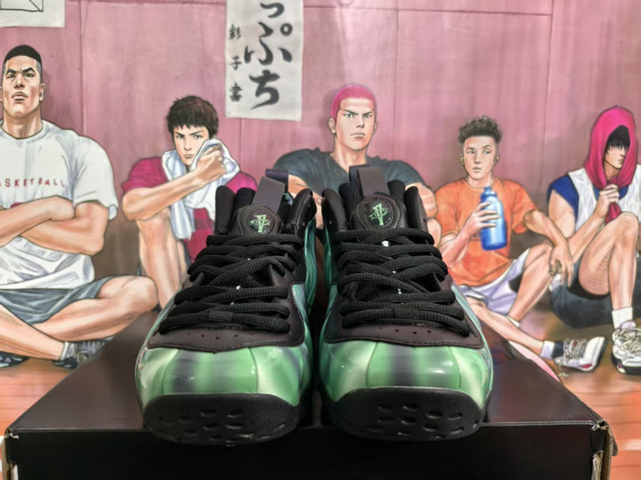Front view of green and black high-top sneakers displayed together on a box.
