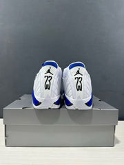 Rear view of the white and blue Jordan Air Jordan 14 sneakers placed on a gray shoe box.